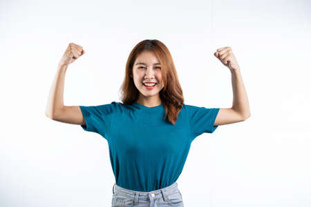 Portrait of an Asian woman smiling and extending her hand to present something with hands gesturing,...