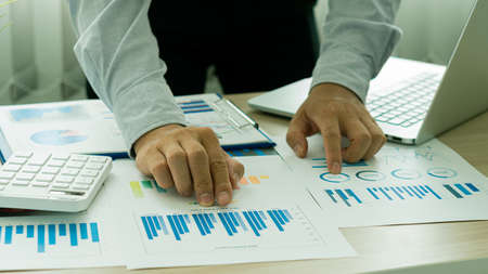 business people working with financial data hand holding pen pointing on charts annual business...