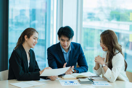small group of young people at a business meeting a team in a modern office planning of work design and brainstorming ideas Hands of a businessman working on documents and laptopsの写真素材