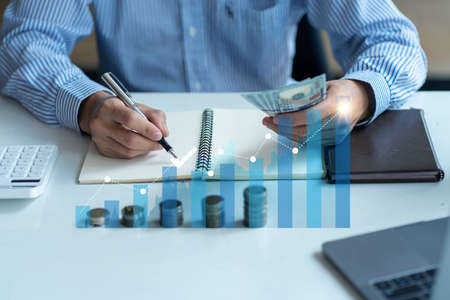 Businessman working on financial sales data analysis and economic growth chart and blockchain technology on financial analysis and marketing sales strategy in the office.の写真素材