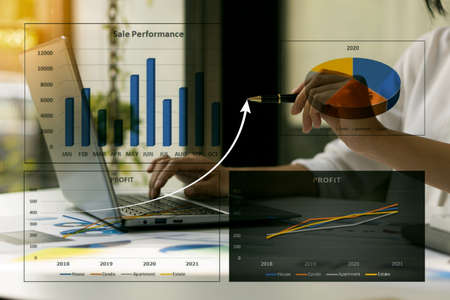 Businessman working on financial sales data analysis and economic growth chart and blockchain...