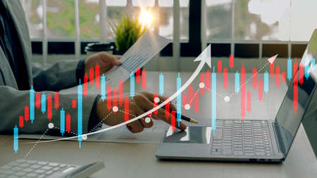 Businessman working on financial sales data analysis and economic growth chart and blockchain...