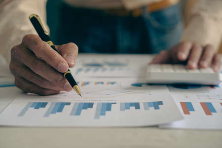 The company's accountant analyzes the expenses on the business desk. financial reporting accountant computer with graph chart business idea Finance and Accountingの写真素材