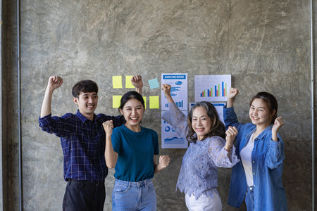 Generations of Asian business teams gather to celebrate success in the conference room. See the...