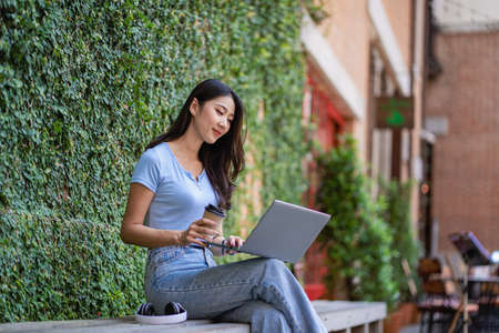 Asian woman in casual clothes working outside the home Happy working on my personal laptop and...