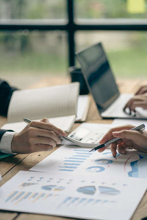 Business team portrait analyzes the top performance of the meeting. Professional investors working on new start-up projects. money manager digital tablet Computers, laptops, calculの写真素材