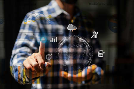 young man holding globe icon pointing graph work document management system big data concept digital transformation of technologyの写真素材