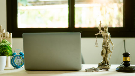 The goddess of justice and the judge's hammer and the laptop on the lawyer Themis table. concept of law and justiceの写真素材