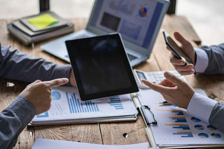 Business team meetings to work together to discuss financial data analysis and marketing business strategy projects. Presentation and brainstorming for profitable company at the ofの写真素材