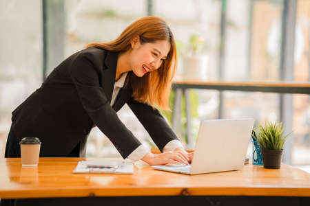 Professional Asian female accountant or financial clerk at her job who works on financial reports. and laptop computers andの写真素材