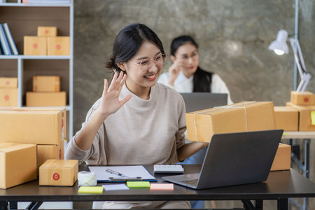 Two independent Asian women working from home small business owners inspect products before delivering them to customers online. shipping packaging Online marketing for SMEs, startの写真素材
