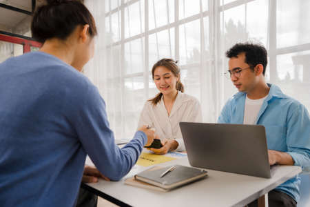 Young Asian businessmen meet in office to write memos. Strategic Planning and Brainstorming Starting a business, the idea of ââa colleagueの写真素材