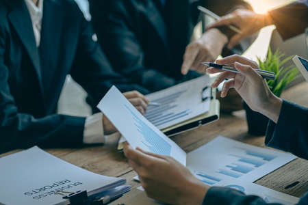 Asian business advisor meeting to analyze and discuss the situation of financial reports in the meeting room for financial investment advisors, accounting concepts.の写真素材