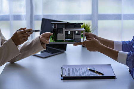 A sales representative is discussing the details before the customer agrees to sign a contract. by...