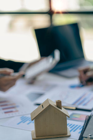 Real estate business concept A rental company employee is calculating the cost for the customer to agree to sign a title contract by explaining the terms and conditions of sale.の写真素材