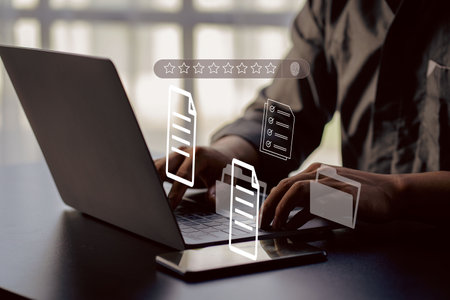 Businessman working on laptop with Document Management System (DMS) installed by IT consultant in office. Software for archiving, searching and managing files and data.の写真素材