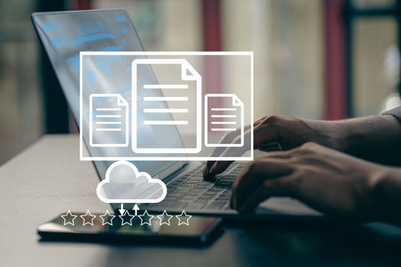 Businessman working on laptop with Document Management System (DMS) installed by IT consultant in office. Software for archiving, searching and managing files and data.の写真素材