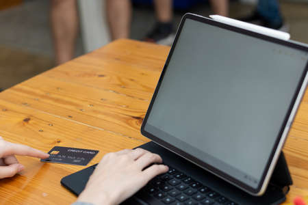 People are using tablets to pay by credit card of travel plane tickets and travel ideas. business...
