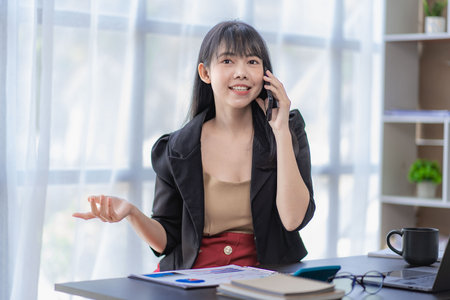 Business Successful Asian Woman Working In Office With Smartphone And And Laptop Financial Documents Financial Account Analysis Conceptの写真素材