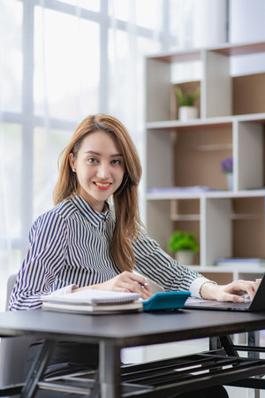 Asian business woman working financial analysis Accounting report, revenue statistics, graph of company performance for profit and growth, research, vertical image.の写真素材