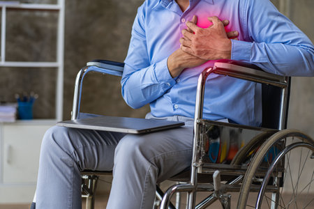 Businessman in a wheelchair working in the office at home