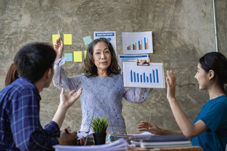 A team of young Asian businessmen, good genes and business successes, brainstorm on new document projects. coworkers working together Strategic planning enjoys working as a team inの写真素材