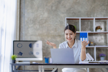 Asian woman working using laptop computer in modern office make an account analysis report real estate investment information tax and financial system conceptsの写真素材