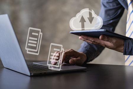 Businessman using laptop computer on digital documents, electronic signing on electronic documents and virtual notepad on screen. paperless office conceptの写真素材