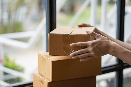 Operators work on receiving boxes and check online orders to prepare the packaging. Sell...
