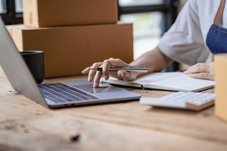 Operators work on receiving boxes and check online orders to prepare the packaging. Sell...