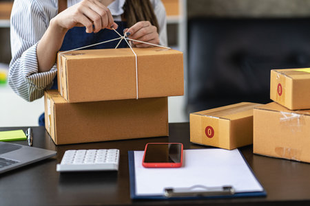 Operators work on receiving boxes and check online orders to prepare the packaging. Sell...