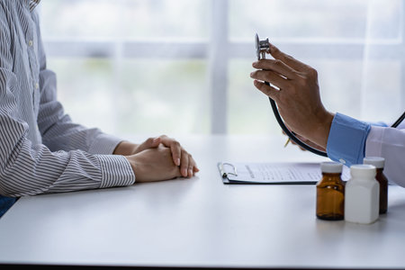 Doctors and patients sit and talk to patients about medications. At the table near the window in the...