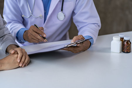 Doctors and patients sit and talk to patients about medications. At the table near the window in the hospital Consultation and advice conceptの写真素材