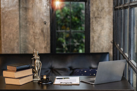 Law office with Judge's hammer book, scales of justice and laptop on lawyer's desk.の写真素材