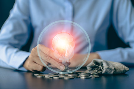 Hand holding a light bulb with innovative and creative ideas. energy and money saving ideasの写真素材