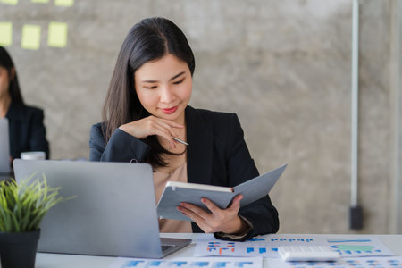 Two Asian business women meet to discuss finances and business information at a modern office.
Young people are consulting, analyzing plans, and working together using data from paの写真素材