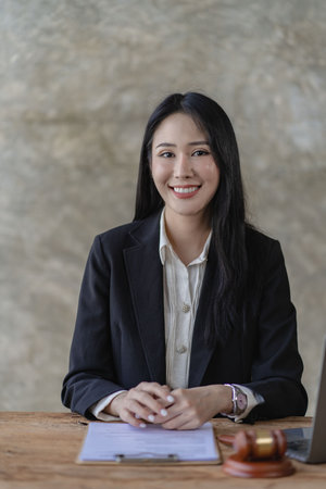 Asian lawyer Work with the scales of the god of justice. A beautiful and professional Asian woman...