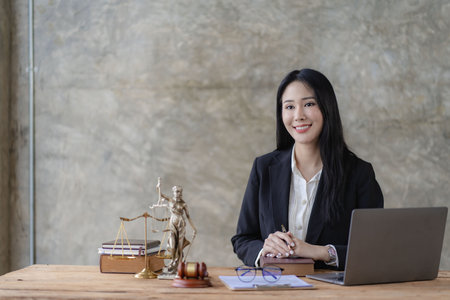 Asian lawyer Work with the scales of the god of justice. A beautiful and professional Asian woman...