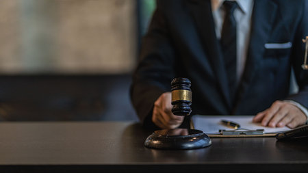 Lawyer's Office of Law Counsel works with the judge's column and the Goddess of Justice's scales on the table with the takamai books and contract documents.の写真素材