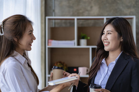 Two Asian women analyzing finances.Two business woman Asian chat exchanging ideas at the meeting.の写真素材