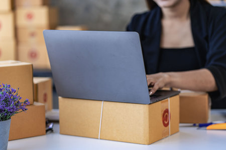 SME business, online sales at home, Asian woman working with boxes and laptops to take orders from customers, parcel delivery concept, online business SMEの写真素材