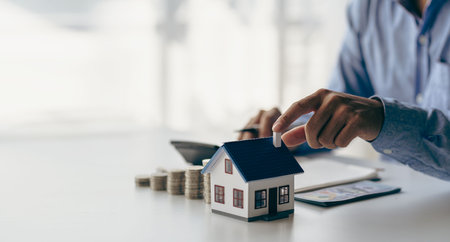 Check list before buying a new home to meet the bank criteria. Close-up shot of silver coin drop and house model Savings by adding your money to the real estate owner in a futuristの写真素材