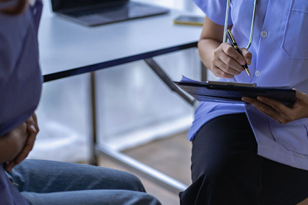 Young female patient with a gynecologist making an appointment to consult Female medical specialist consulting stomachache patient Abdominal discomfort due to menstrual pain pancreの写真素材