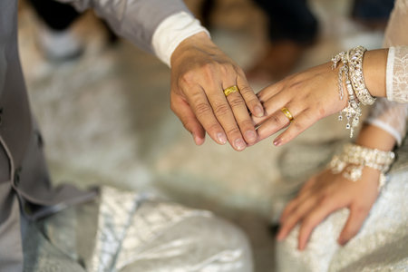 Sacred thread tied in a Thai wedding ceremony The hands of the bride and groom are tied with...