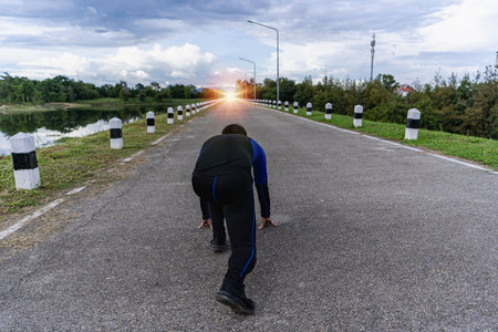 Male runner prepares to run on the road to ambition. Start over with ambitions, challenges, plans,...
