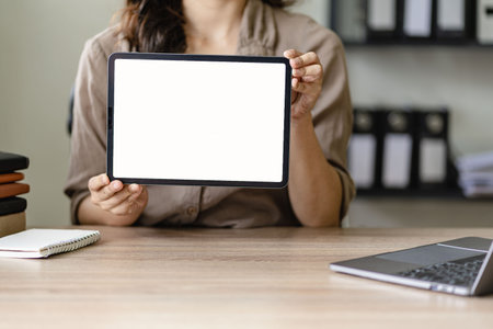 Woman holding tablet with white screen for advertisement
