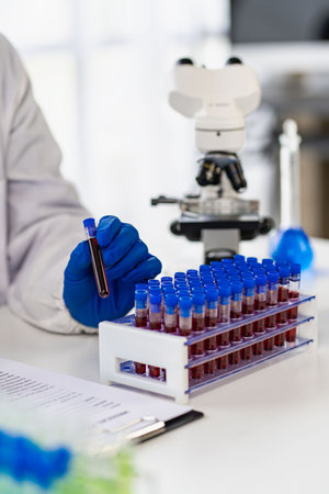 Professional doctor examining arterial blood sample, professional research in nurse with microscope...