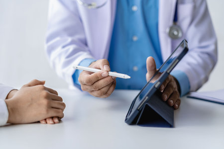 Doctor talking to patient in clinic office Female patient sitting in medical chair while explaining...