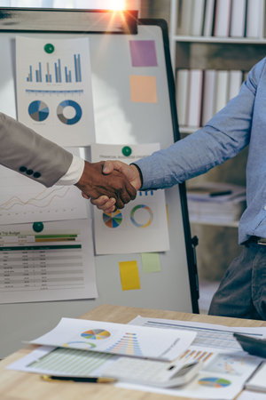 Businessmen shaking hands during a meeting to sign an agreement and a successful business...