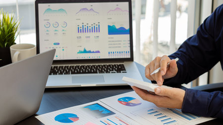 Hand of a business man using a calculator to check financial accounts, check expenditures and...
